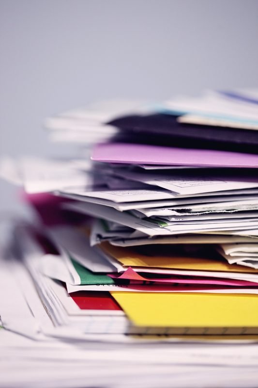 A pile of colored paper and card stock