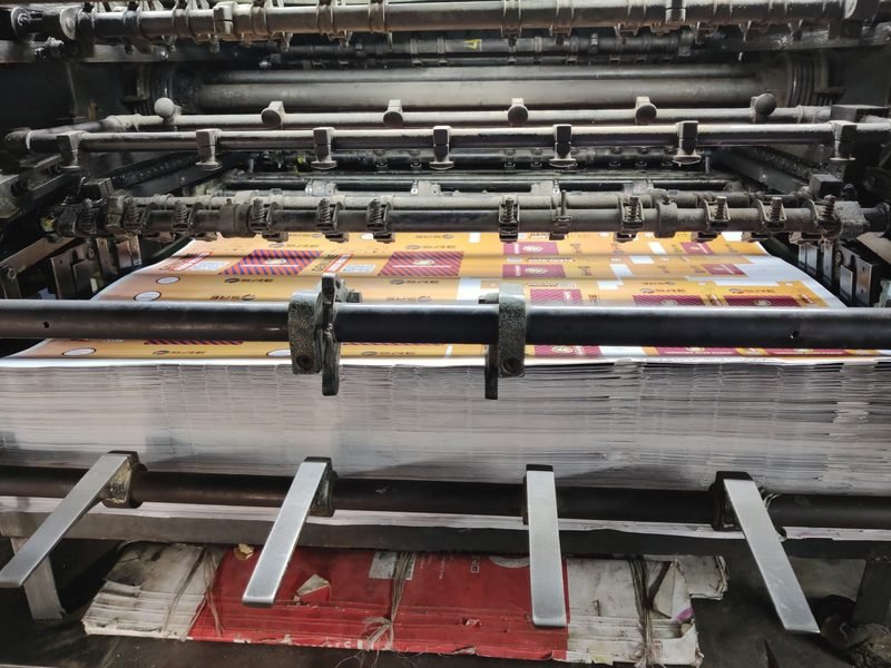 A delivery stack building up at the end of a sheet-fed press
