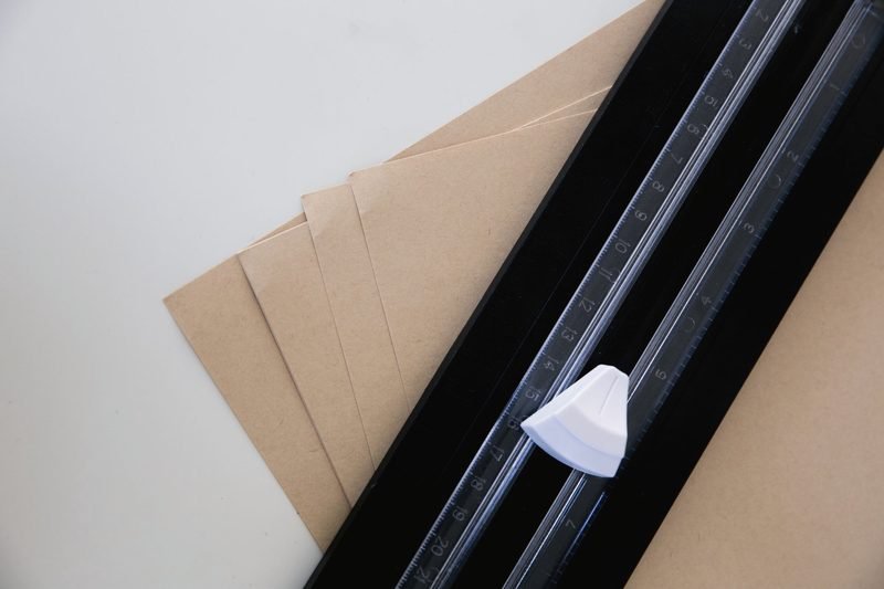 A paper trimmer blade resting on kraft paper